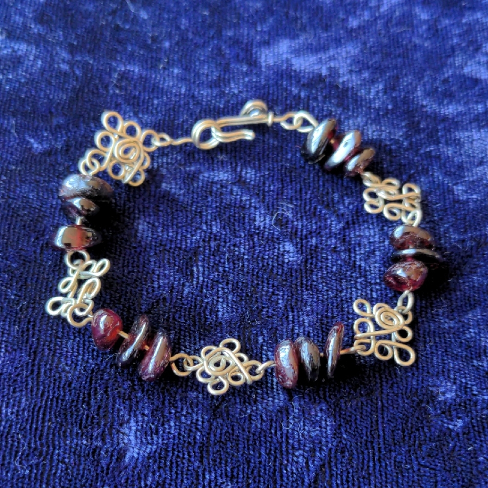 Vintage silver tone artisan made filigree bracelet with natural garnet stones